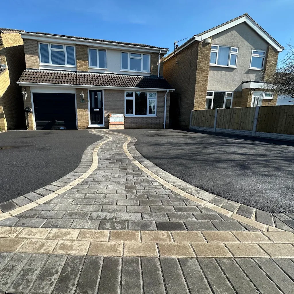 Driveways project — Charcoal block paving with a curved decorative border and pathway.